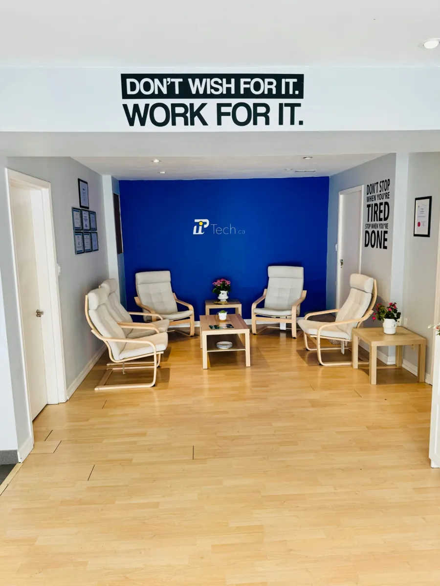 PiTech reception lounge at 1925 Russet Way with the blue brand wall and Work For It motto