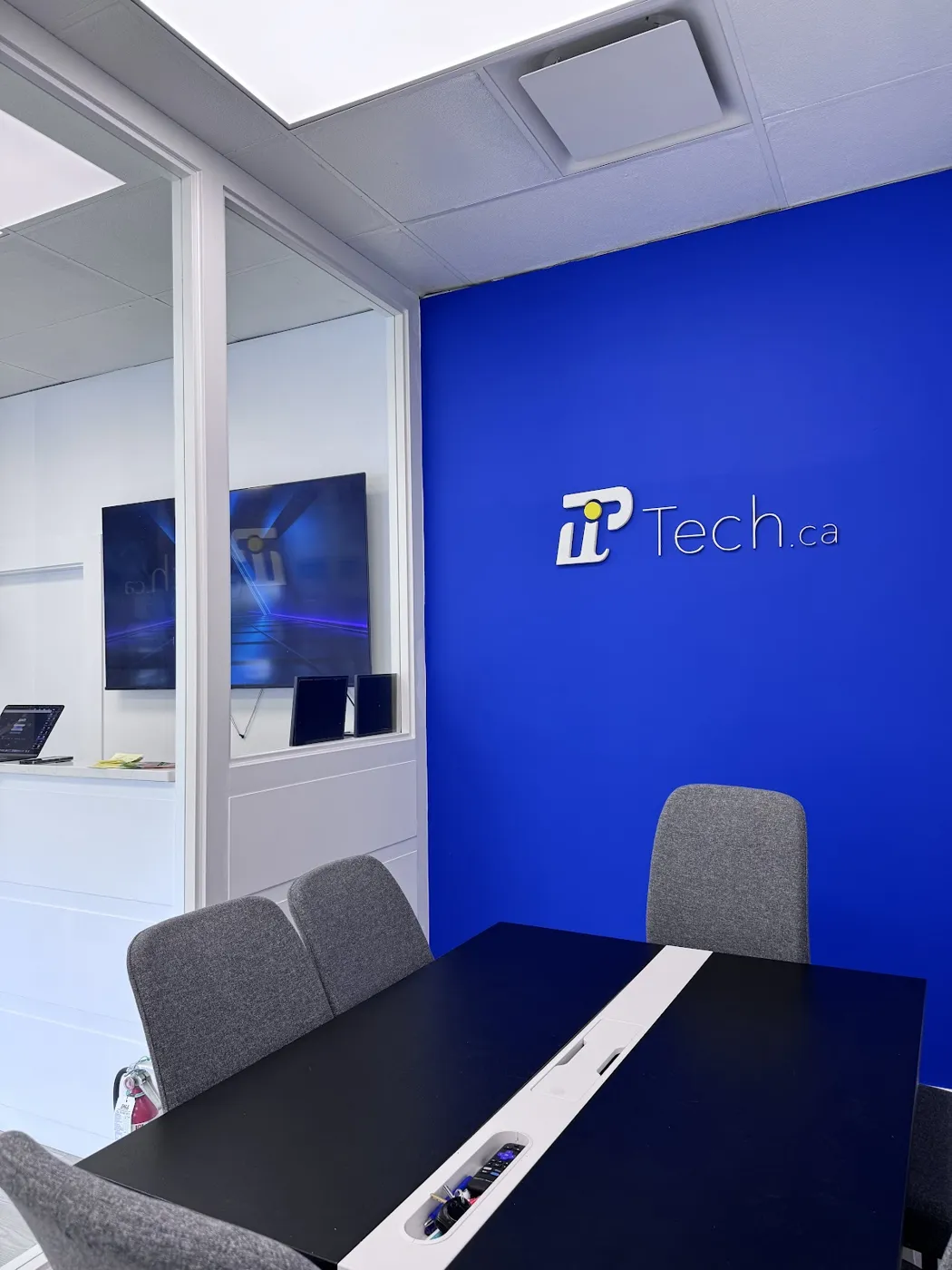PiTech boardroom with the blue PiTech brand wall at 1814 Marine Drive
