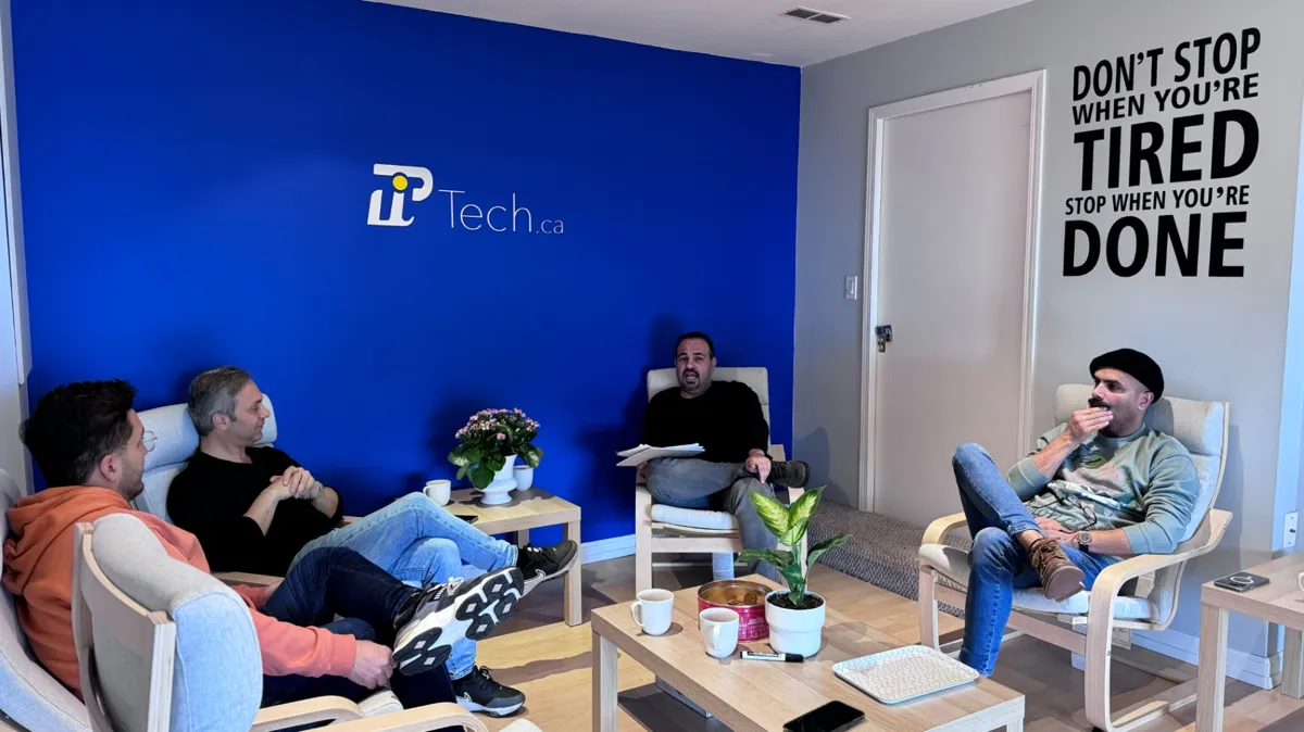 PiTech leadership team meeting in front of the blue PiTech wall at the 1925 Russet Way office in West Vancouver