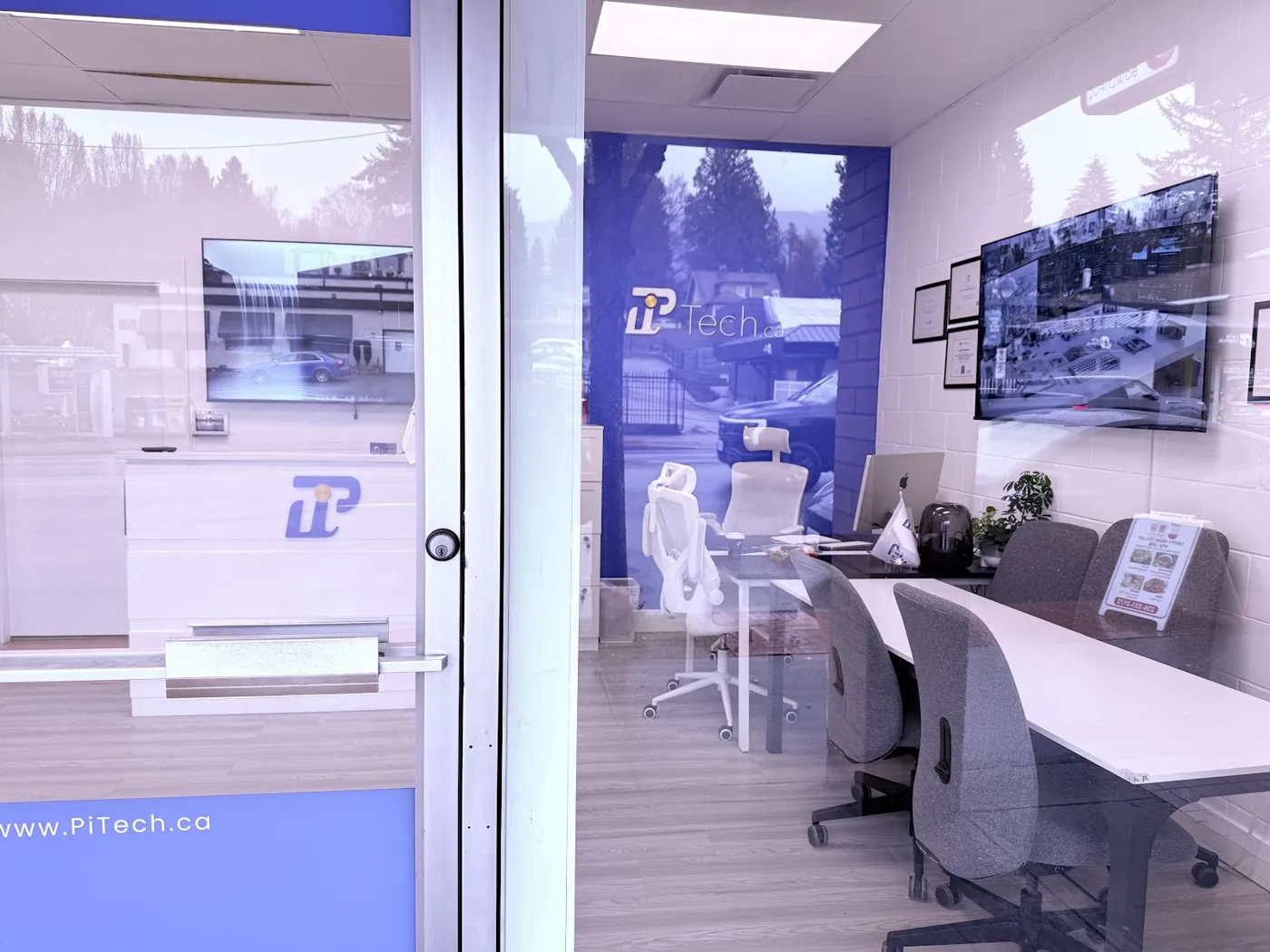 Glass walled PiTech studio and workstations inside the Marine Drive office